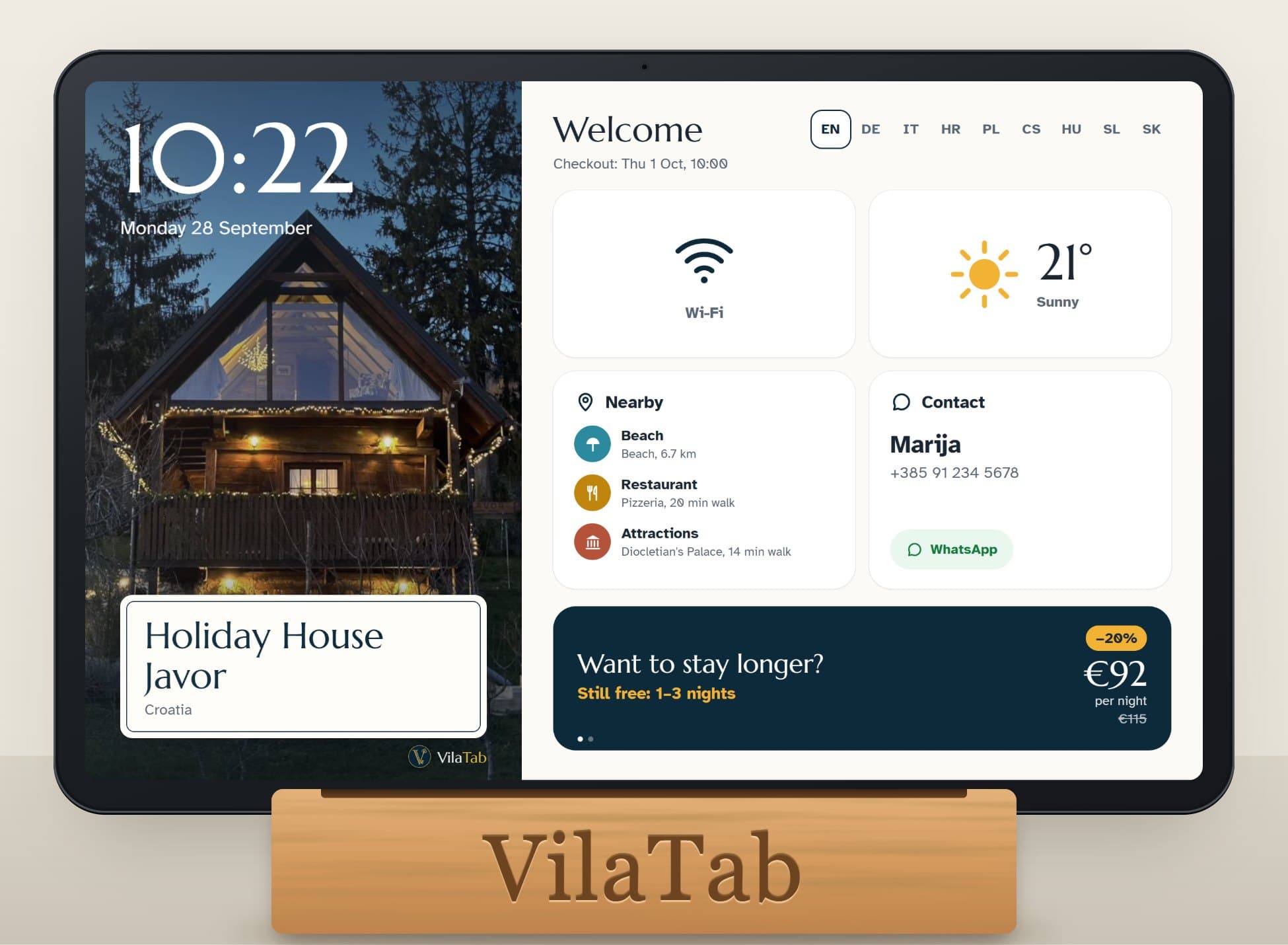 The VilaTab tablet on its wooden stand, showing Wi-Fi, weather, nearby places, the host’s contact and an offer to stay longer
